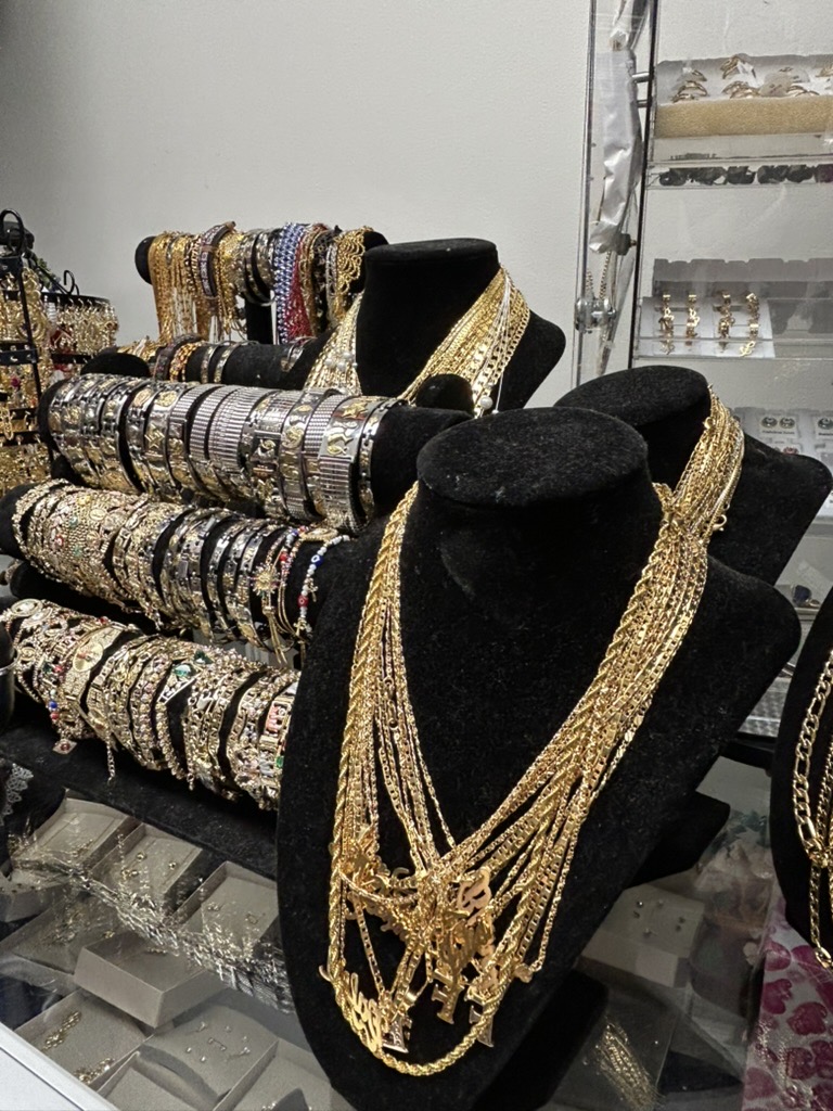 Necklaces, bracelets, and earrings on the shop’s jewelry display